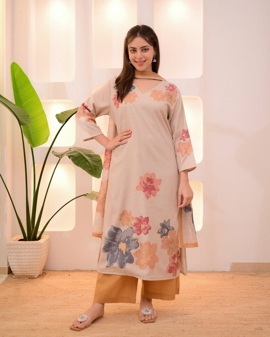 This outfit appears to be a cotton salwar kameez set, featuring a light pink kurta with a floral print.