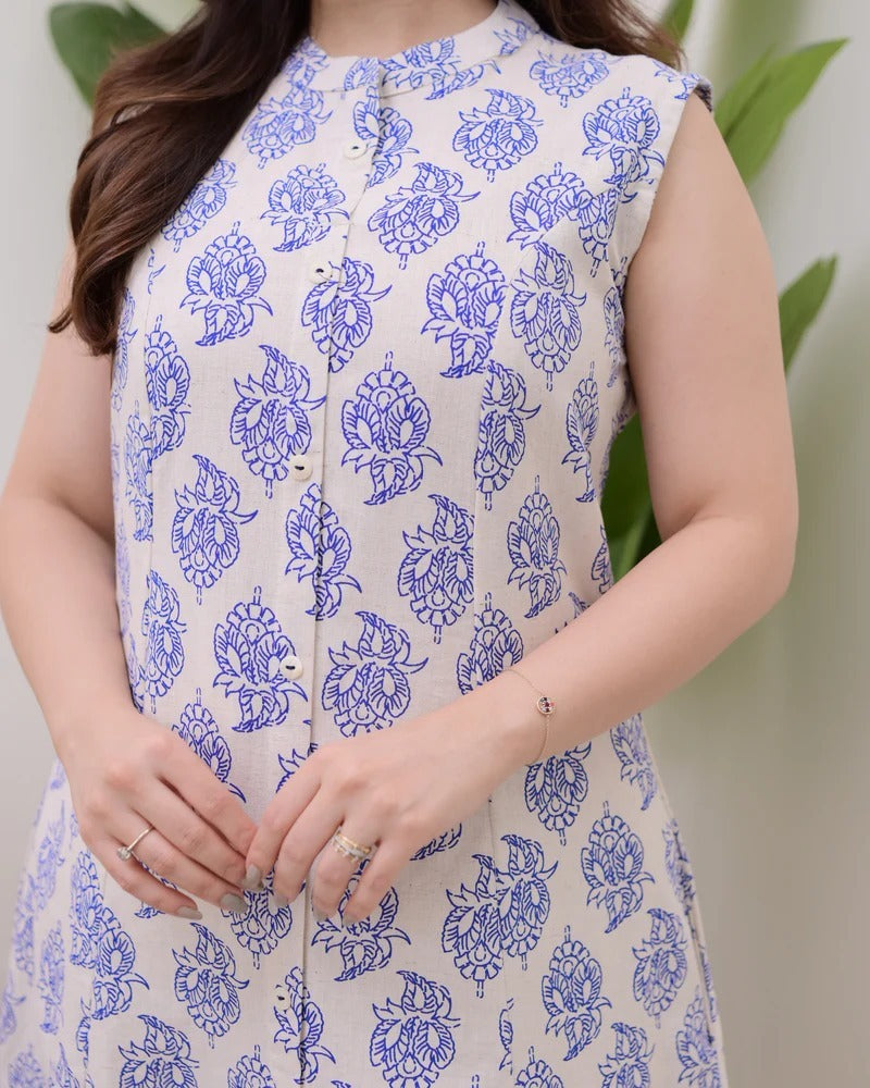 A sleeveless, knee-length kurti featuring a band collar and a full button-down placket.