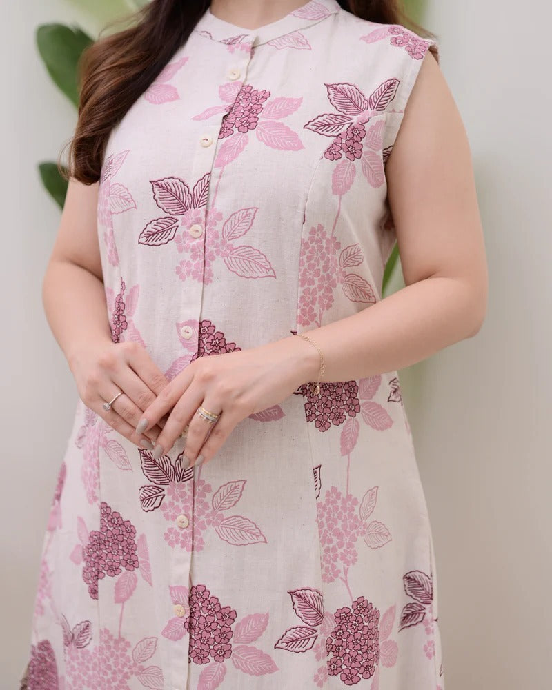 A sleeveless, knee-length kurti featuring a band collar and a full button-down placket.